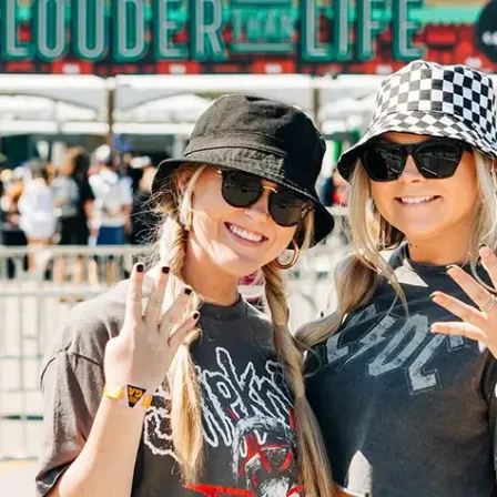 Two fans in bucket hats outside the Louder Than Life festival gates