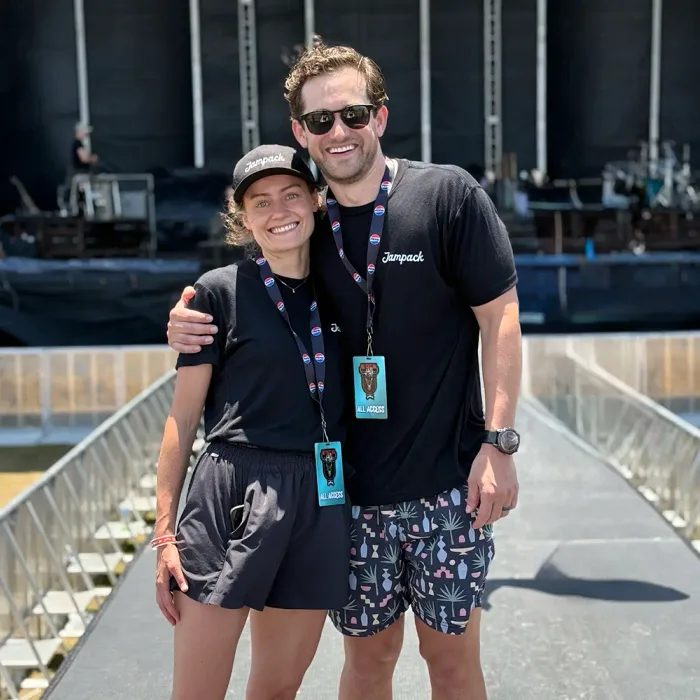 Two Jampack staff wearing event laminates on a festival site