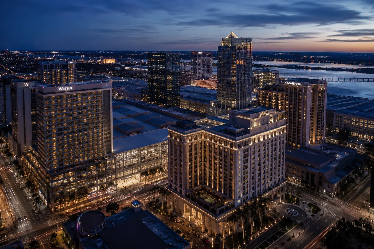 Convention-district hotels at dusk, the Westin and Omni among them, beside the convention centre and waterfront.